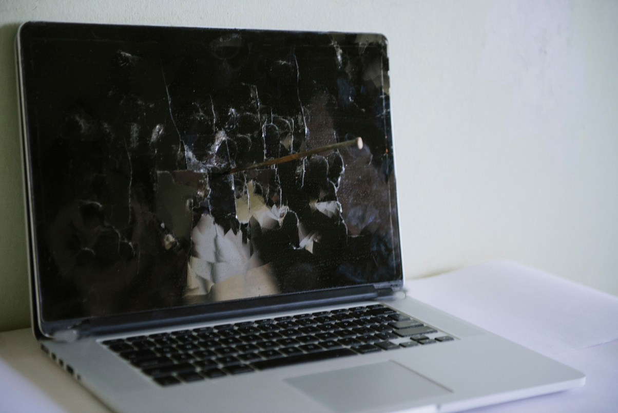 Broken laptop screen on a light background